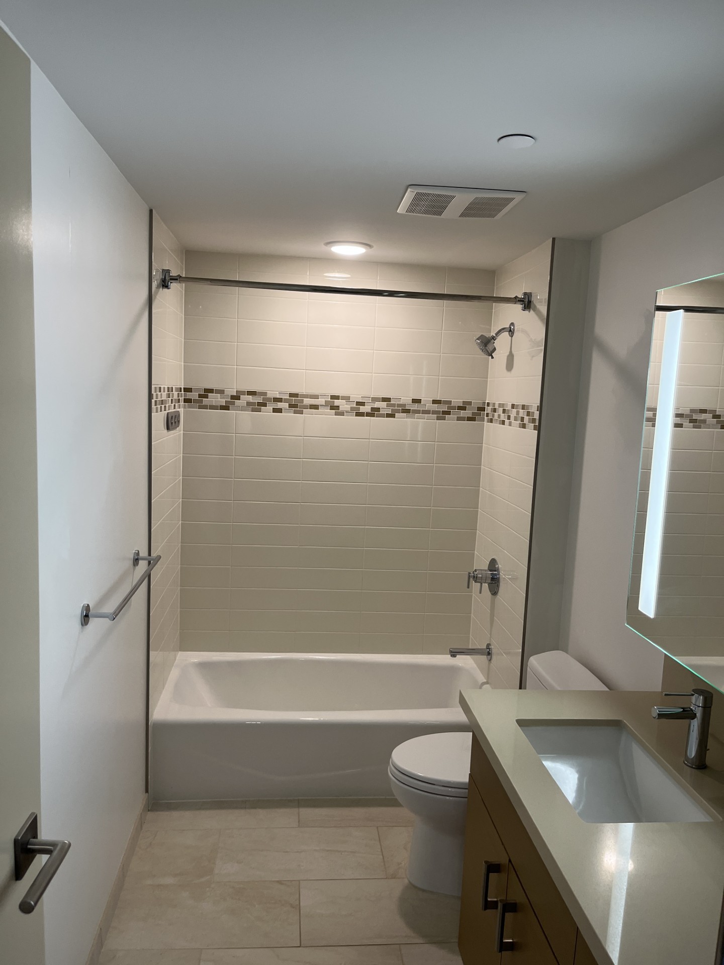 A white bathroom with a tub, toilet, and sink.